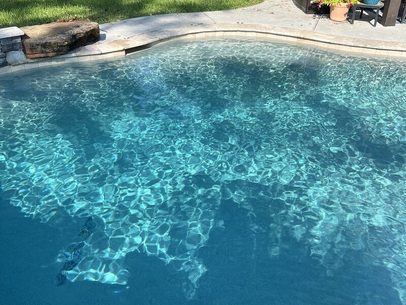 Pool with rock waterfall and clear blue water in Cinco Ranch TX
