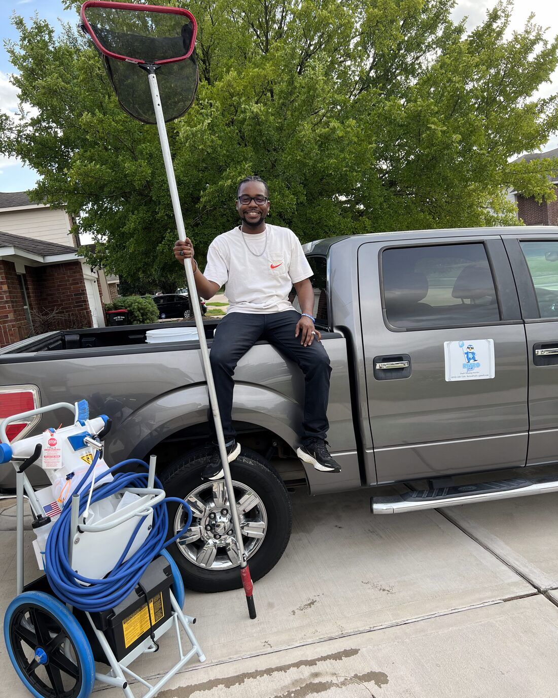 Retro Ink Pools owner standing with the branded service truck and equipment in Katy, TX